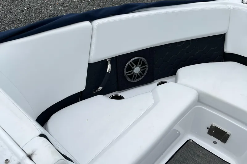 Slide: The Image of 2022 Four Winns H4 OB boat interior with white seating and speaker. - 8