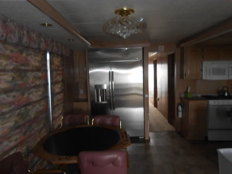 Slide: The Image of Interior of 1999 Horizon houseboat with kitchen and dining area. - 13