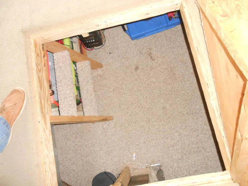Slide: The Image of Carpeted hatch opening on 1999 Horizon houseboat, revealing storage area with steps. - 16