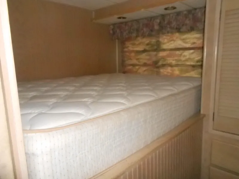 Slide: The Image of Cozy bedroom in 1999 Horizon houseboat with plush mattress and floral curtains. - 17