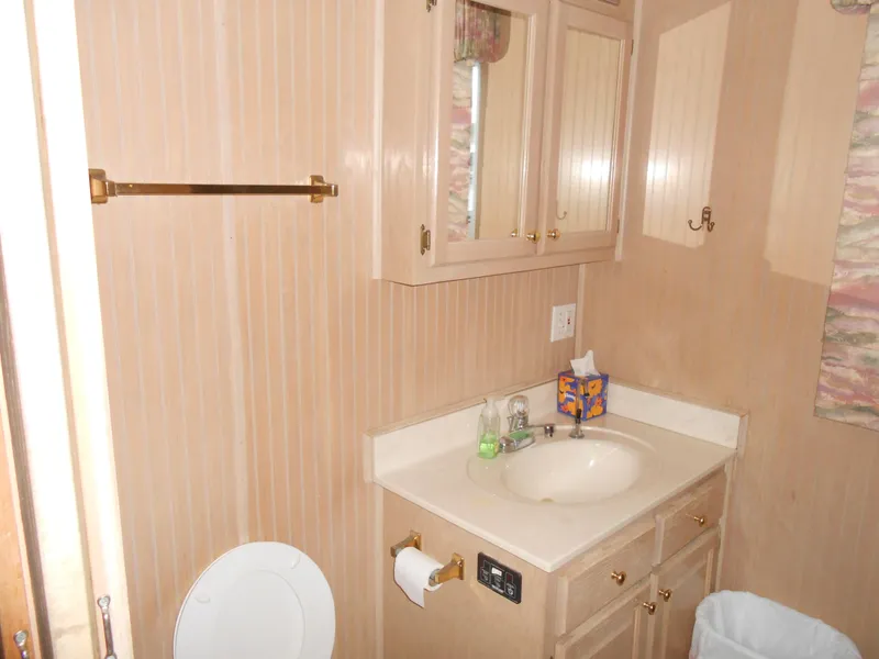 Slide: The Image of Bathroom interior of 1999 Horizon houseboat with sink, cabinets, and beige decor. - 18