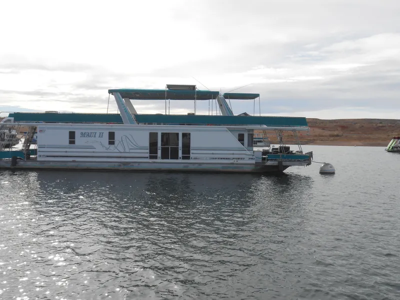 Slide: The Image of 1999 Horizon houseboat on calm water with overcast sky. - 2