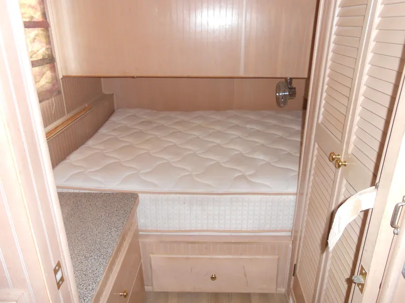 Slide: The Image of Cozy bedroom in 1999 Horizon houseboat with wooden cabinetry and comfortable mattress. - 23