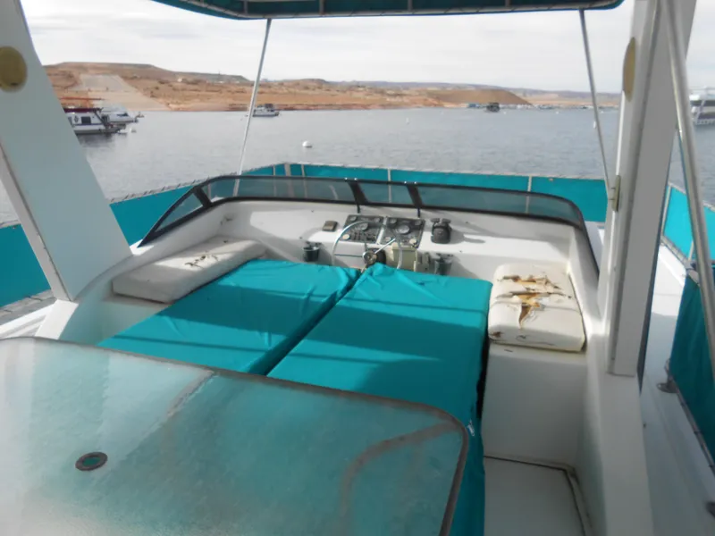 Slide: The Image of 1999 Horizon houseboat deck with turquoise seating, overlooking calm waters and distant shoreline. - 29