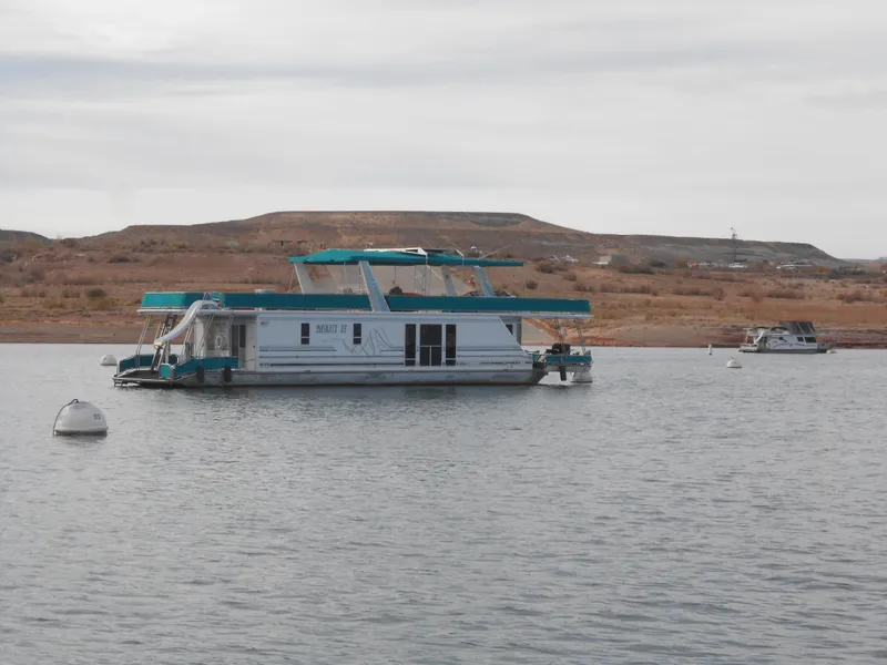Slide: The Image of 1999 Horizon houseboat on a calm lake with distant hills. - 3