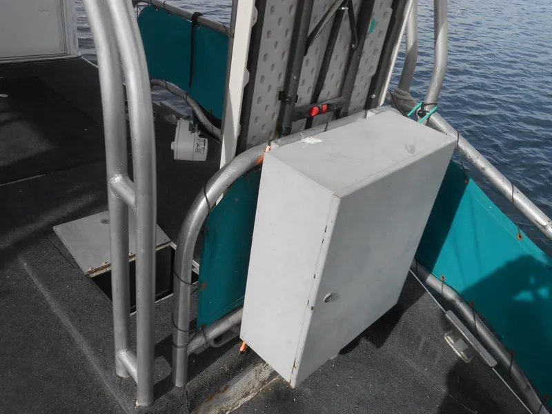Slide: The Image of Control panel on 1999 Horizon houseboat deck with metal railings and teal accents. - 31