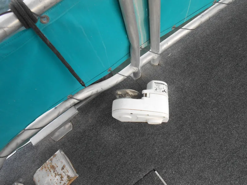 Slide: The Image of White device on carpeted floor of 1999 Horizon houseboat, near teal panel and metal railing. - 33