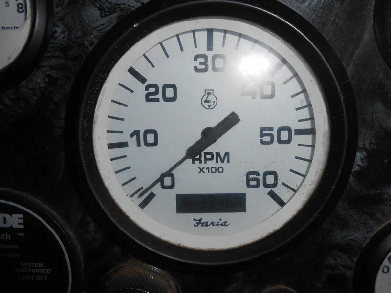 Slide: The Image of Close-up of a 1999 Horizon houseboat RPM gauge displaying engine speed. - 35
