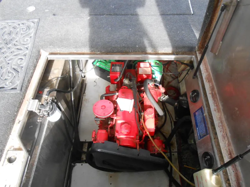 Slide: The Image of Engine compartment of a 1999 Horizon houseboat, featuring a red motor and surrounding components. - 41