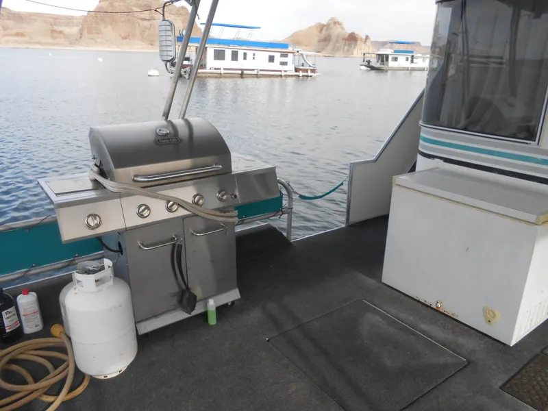 Slide: The Image of Houseboat deck with grill, propane tank, and scenic lake view. Horizon model, 1999. - 7