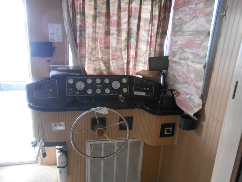 Slide: The Image of Interior helm of a 1999 Horizon houseboat with steering wheel and control panel. - 9
