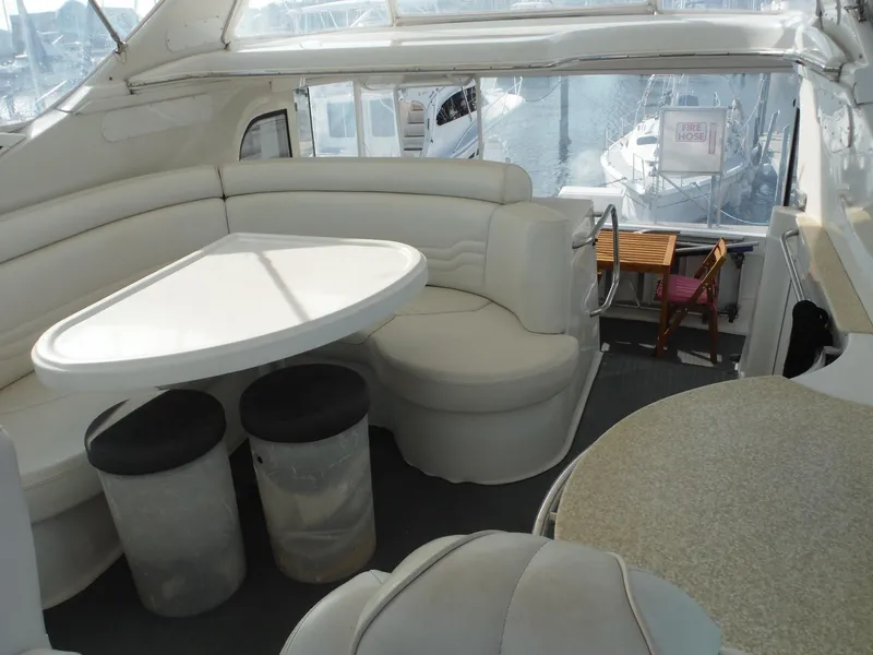 Slide: The Image of Interior of 2001 Carver 466 Motor Yacht with white seating and table. - 10