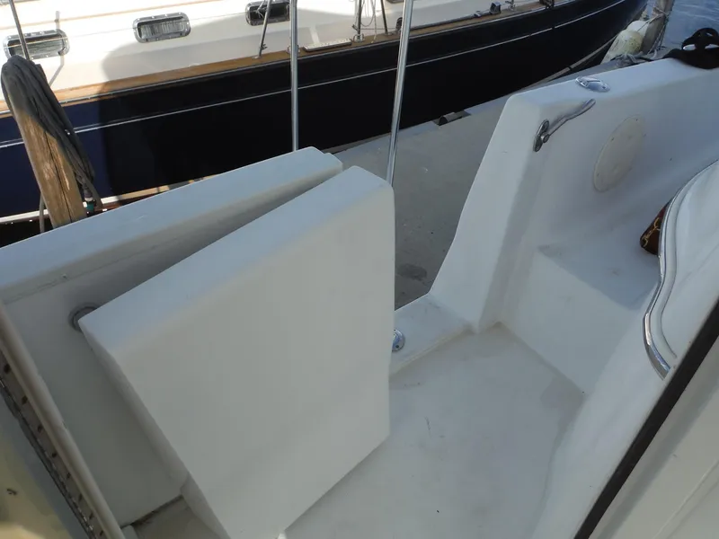 Slide: The Image of 2001 Carver 466 Motor Yacht deck area with white seating and railing. - 15