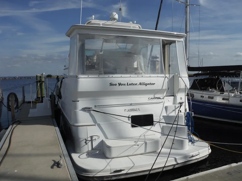 Slide: The Image of 2001 Carver 466 Motor Yacht docked, rear view with "See You Later Alligator" text. - 2