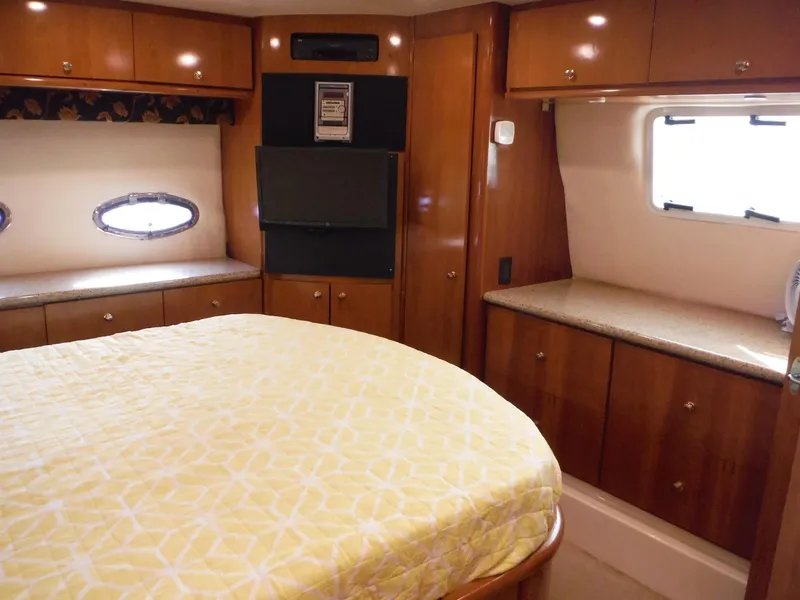 Slide: The Image of 2001 Carver 466 Motor Yacht bedroom with wood cabinetry and yellow bedding. - 24