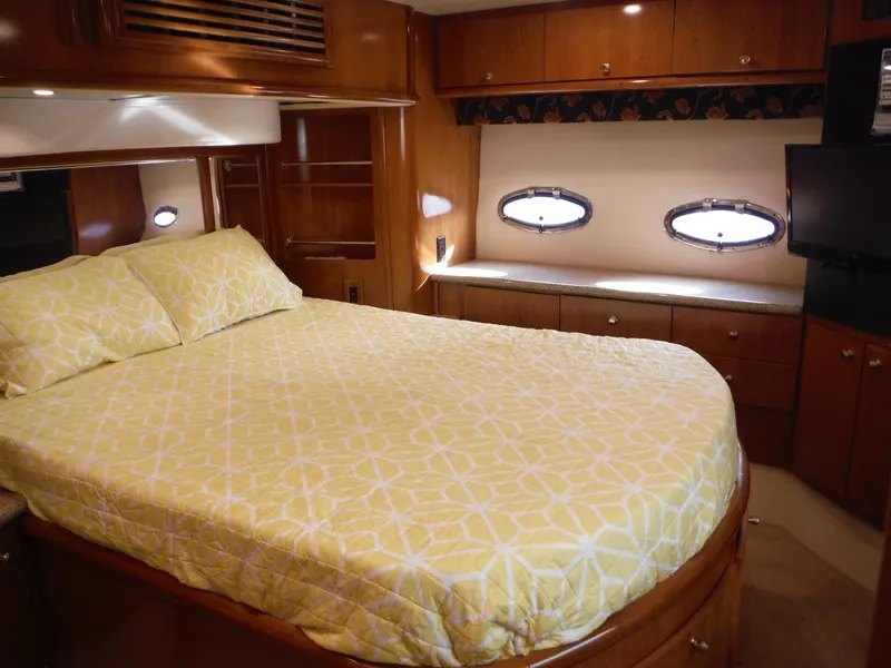 Slide: The Image of Luxurious bedroom in 2001 Carver 466 Motor Yacht with yellow bedding and wooden cabinetry. - 25