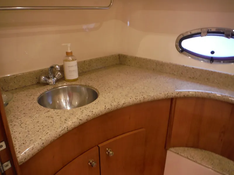 Slide: The Image of Luxurious bathroom in 2001 Carver 466 Motor Yacht with granite countertop and stainless steel sink. - 29