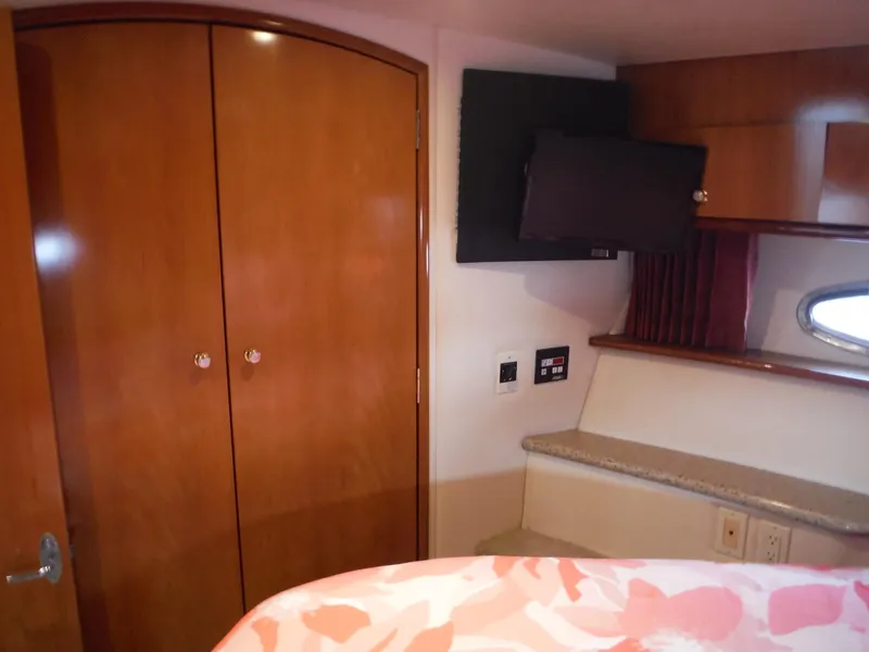 Slide: The Image of Interior of 2001 Carver 466 Motor Yacht with wood cabinets and mounted TV. - 36
