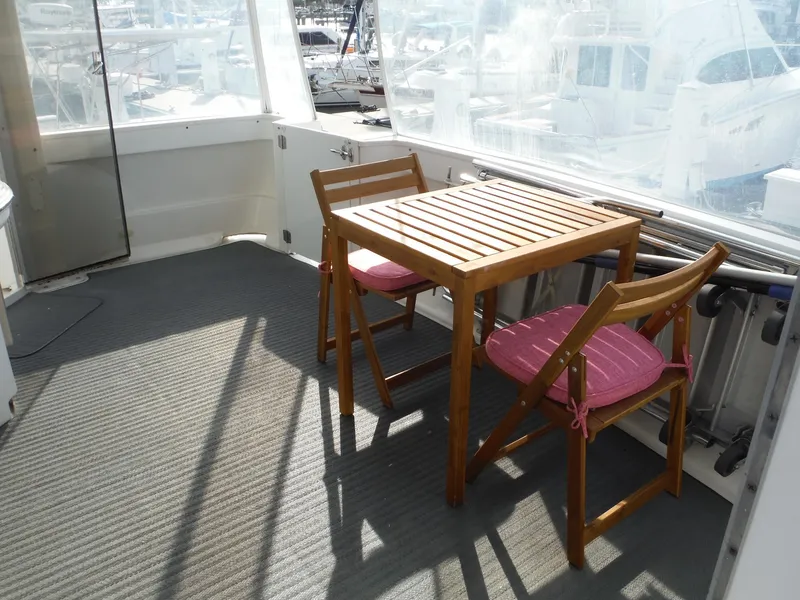 Slide: The Image of Wooden table and chairs on 2001 Carver 466 Motor Yacht deck. - 4
