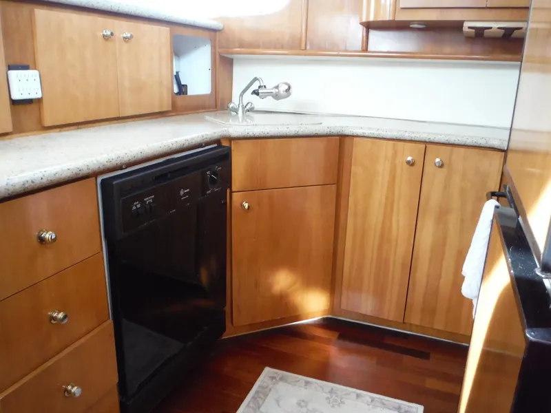 Slide: The Image of Luxurious kitchen interior of 2001 Carver 466 Motor Yacht with wooden cabinets and modern appliances. - 40