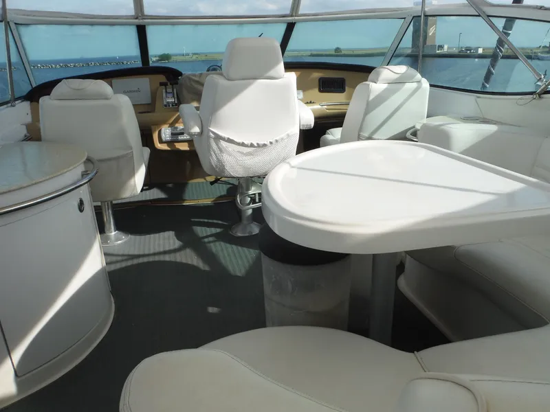 Slide: The Image of Interior of 2001 Carver 466 Motor Yacht with white seating and table. - 6