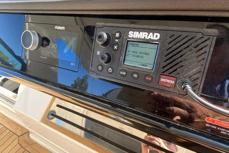 Slide: The Image of 2019 Sea Ray SLX 400 dashboard with navigation screens and steering wheel. - 14