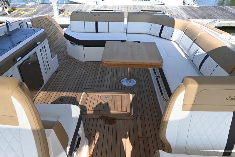 Slide: The Image of Interior of 2019 Sea Ray SLX 400 boat with luxurious seating and wood flooring. - 19