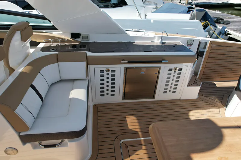 Slide: The Image of 2019 Sea Ray SLX 400 boat with luxurious seating and table on deck. - 23