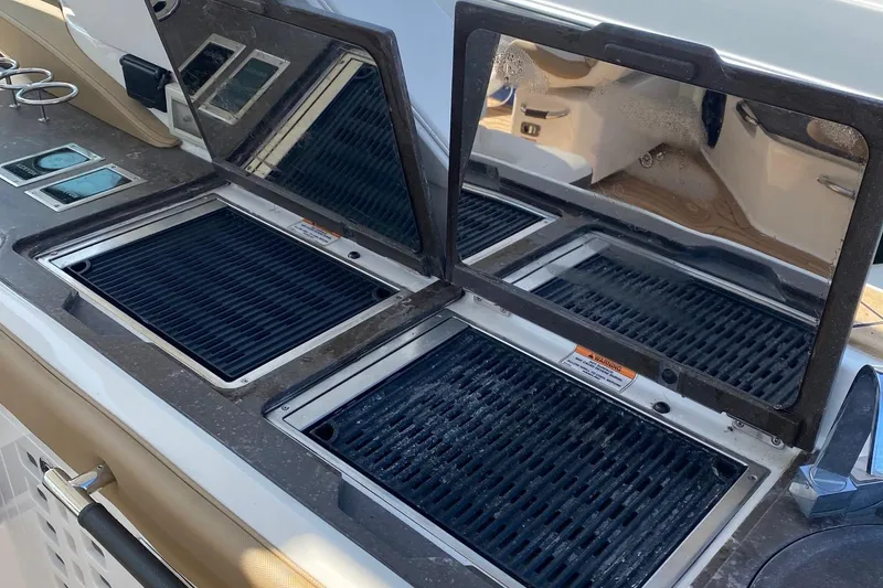 Slide: The Image of Luxurious 2019 Sea Ray SLX 400 yacht interior with seating and kitchenette. - 24