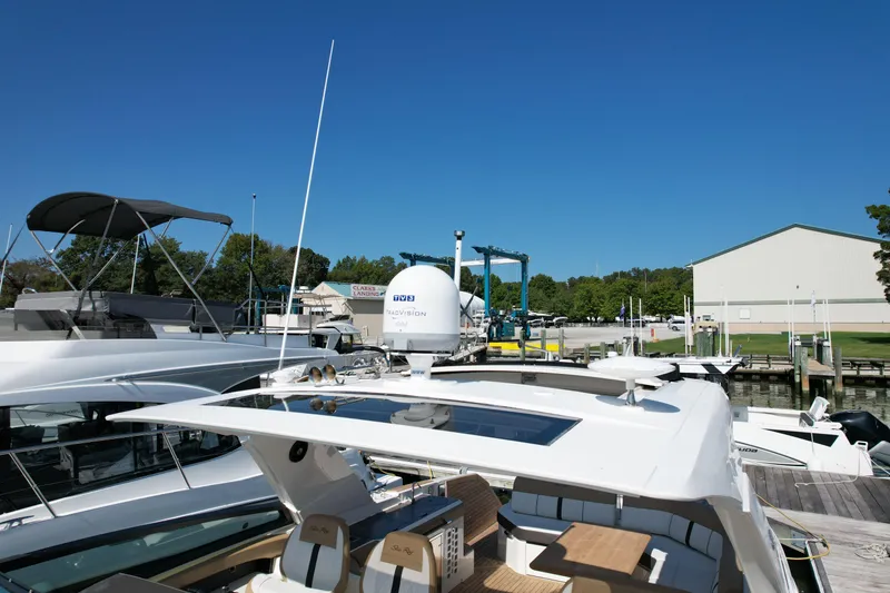 Slide: The Image of 2019 Sea Ray SLX 400 yacht docked at marina under clear blue sky. - 29