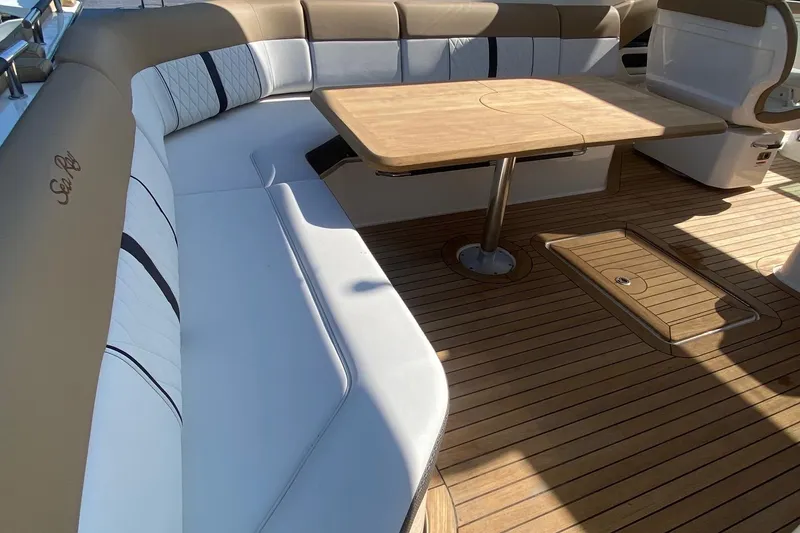 Slide: The Image of 2019 Sea Ray SLX 400 yacht with spacious deck seating and wooden table. - 31