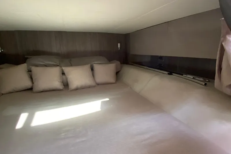 Slide: The Image of Luxurious cabin interior of 2019 Sea Ray SLX 400 with cozy bedding and TV. - 41