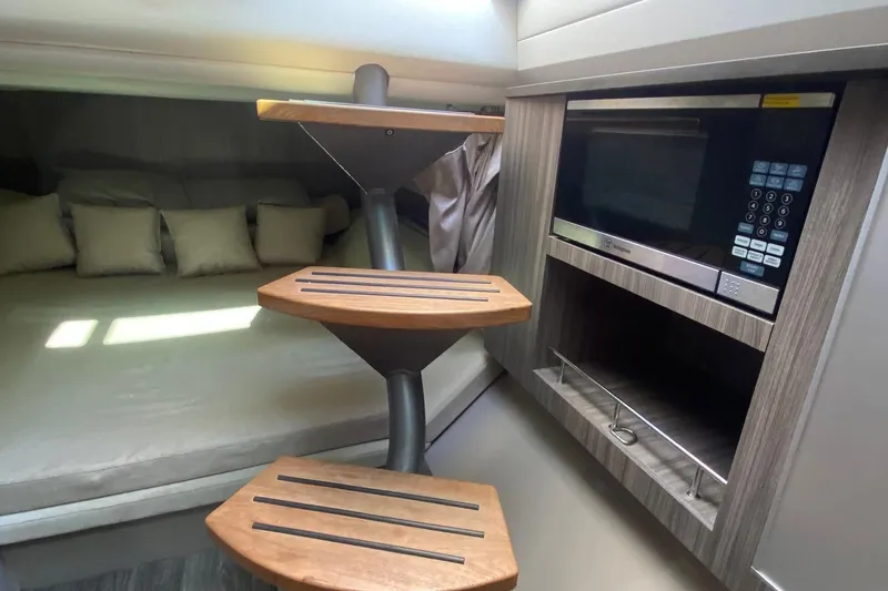 Slide: The Image of Interior cabin of 2019 Sea Ray SLX 400 with cozy bedding and pillows. - 43
