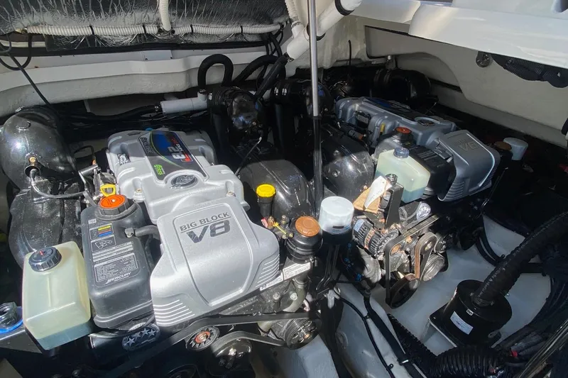 Slide: The Image of 2019 Sea Ray SLX 400 cabin interior with bed, wooden steps, and microwave. - 44