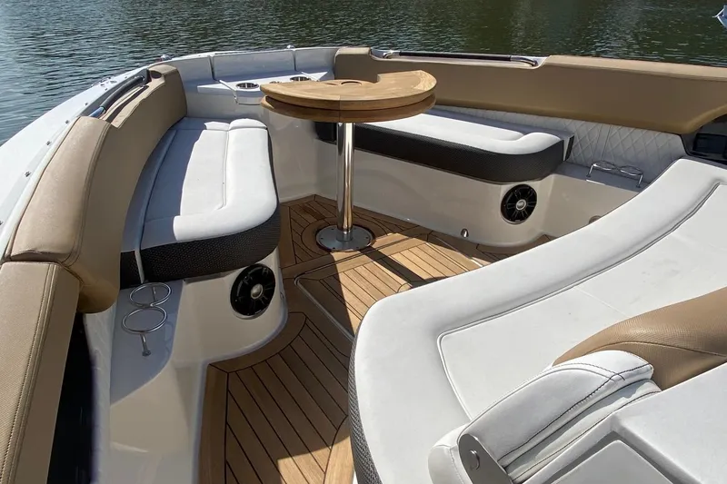 Slide: The Image of Luxurious 2019 Sea Ray SLX 400 boat interior with elegant seating and wooden table. - 7