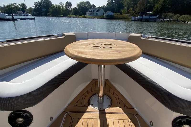 Slide: The Image of Luxurious 2019 Sea Ray SLX 400 boat interior with elegant seating and wooden table. - 8