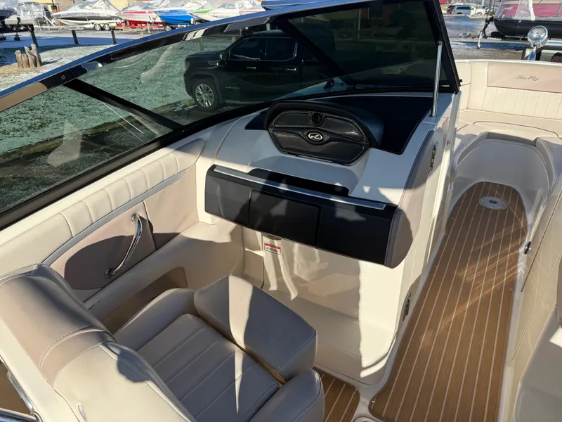 Slide: The Image of 2005 Sea Ray 270 SLX boat interior with beige seating and wood-style flooring. - 12