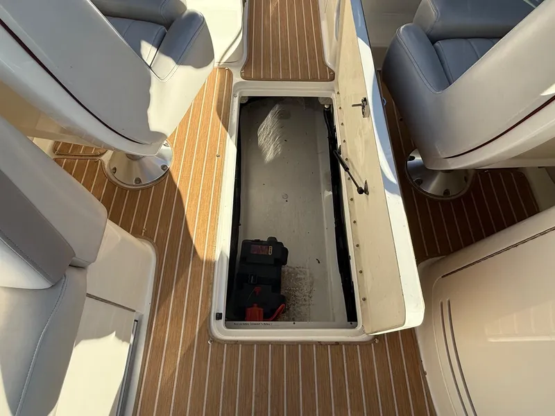 Slide: The Image of 2005 Sea Ray 270 SLX boat interior with open storage compartment and seating. - 14