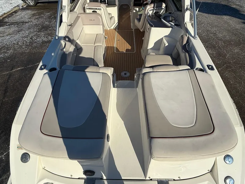 Slide: The Image of 2005 Sea Ray 270 SLX boat interior with beige seating and wood accents. - 15