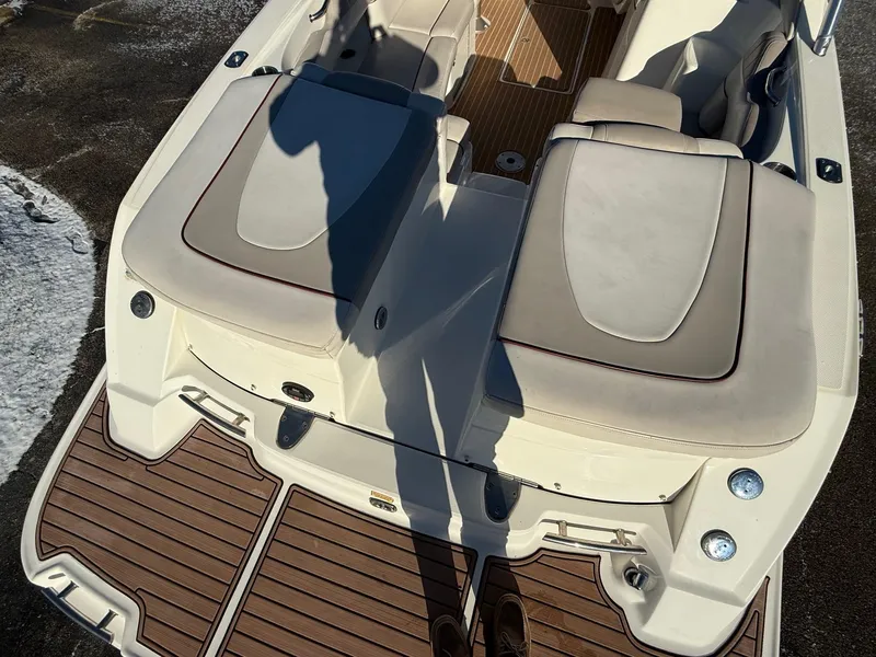 Slide: The Image of 2005 Sea Ray 270 SLX boat with beige seating and wooden deck. - 16