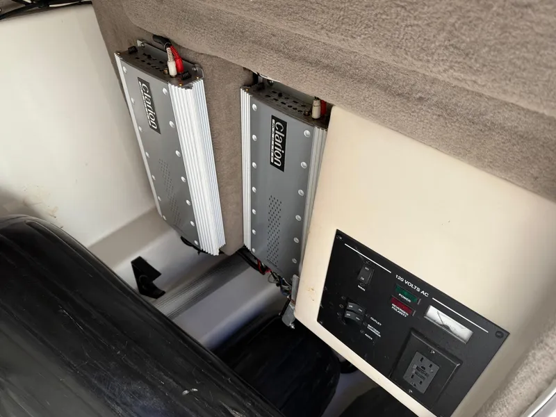 Slide: The Image of 2005 Sea Ray 270 SLX interior with Clarion amplifiers and control panel. - 18