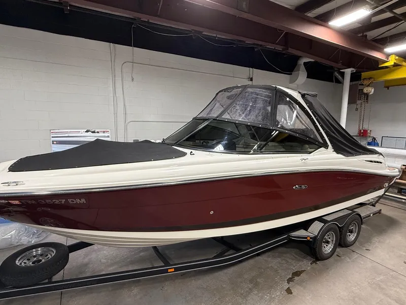 Slide: The Image of 2005 Sea Ray 270 SLX boat on trailer in indoor storage. - 21