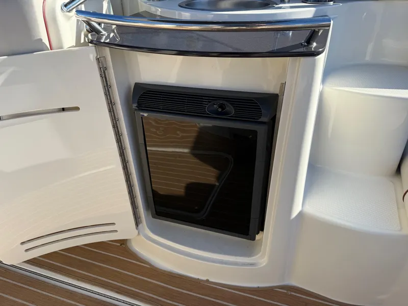 Slide: The Image of 2005 Sea Ray 270 SLX boat interior with open cabinet and mini fridge. - 7