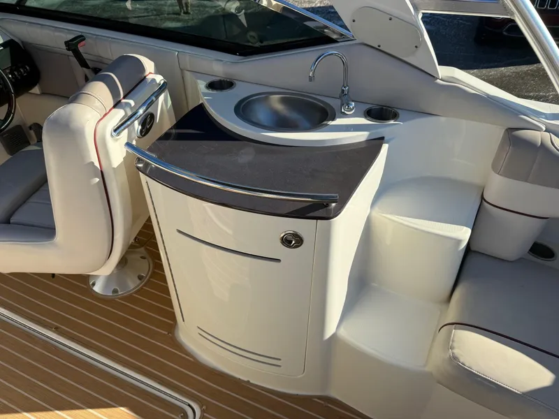 Slide: The Image of 2005 Sea Ray 270 SLX boat interior with sink and seating area. - 8