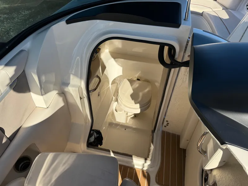 Slide: The Image of 2005 Sea Ray 270 SLX boat interior with compact marine toilet. - 9