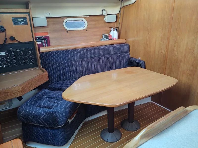 Slide: The Image of Catalina 350 MK II 2006 interior with wooden table and blue cushioned seating. - 25