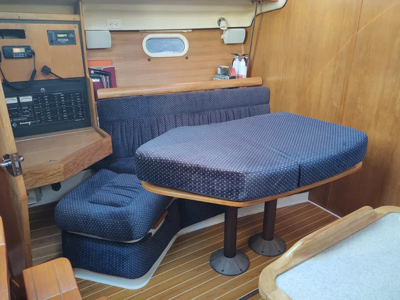 Slide: The Image of Interior of 2006 Catalina 350 MK II sailboat with cushioned seating and wooden accents. - 26