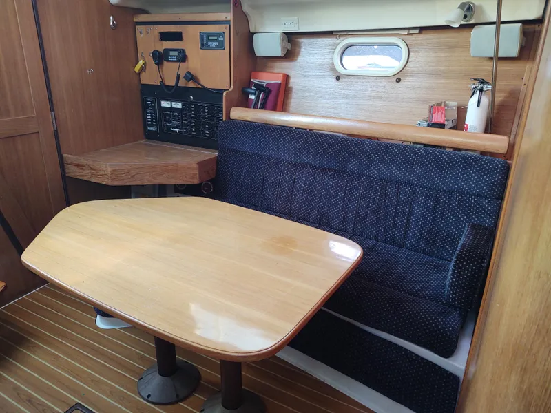 Slide: The Image of Interior of 2006 Catalina 350 MK II sailboat with wooden table and seating area. - 27