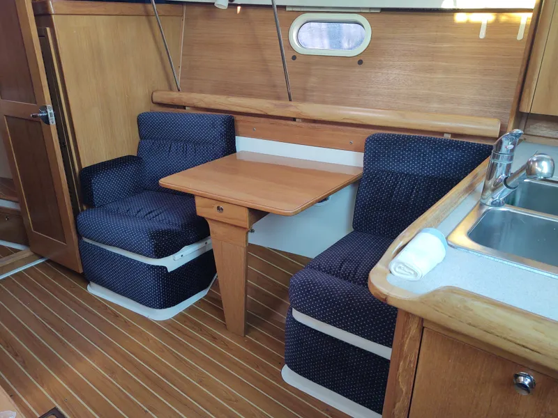 Slide: The Image of 2006 Catalina 350 MK II interior with cozy seating and wooden table. - 28
