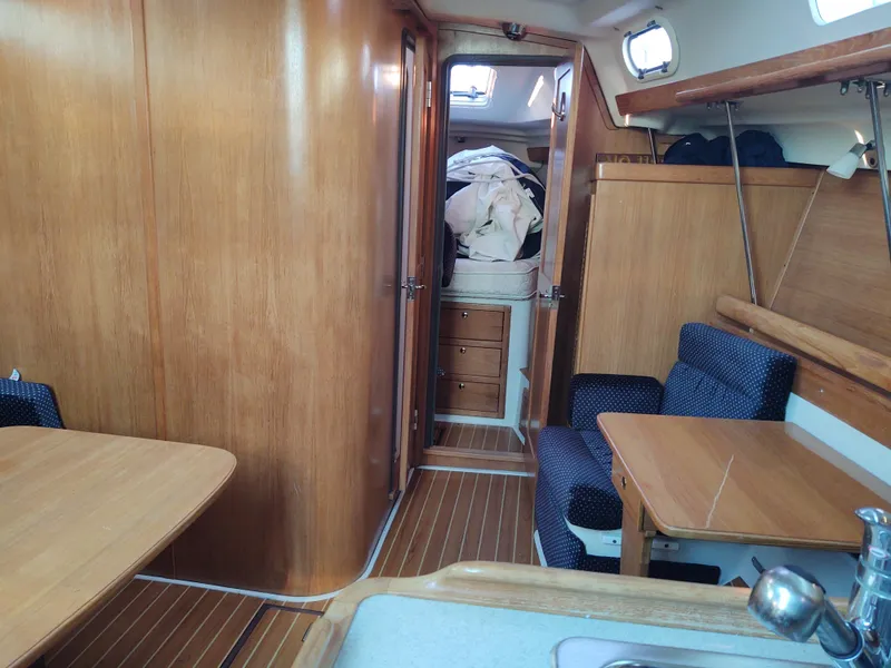 Slide: The Image of Interior of 2006 Catalina 350 MK II sailboat with wooden furnishings and seating area. - 29